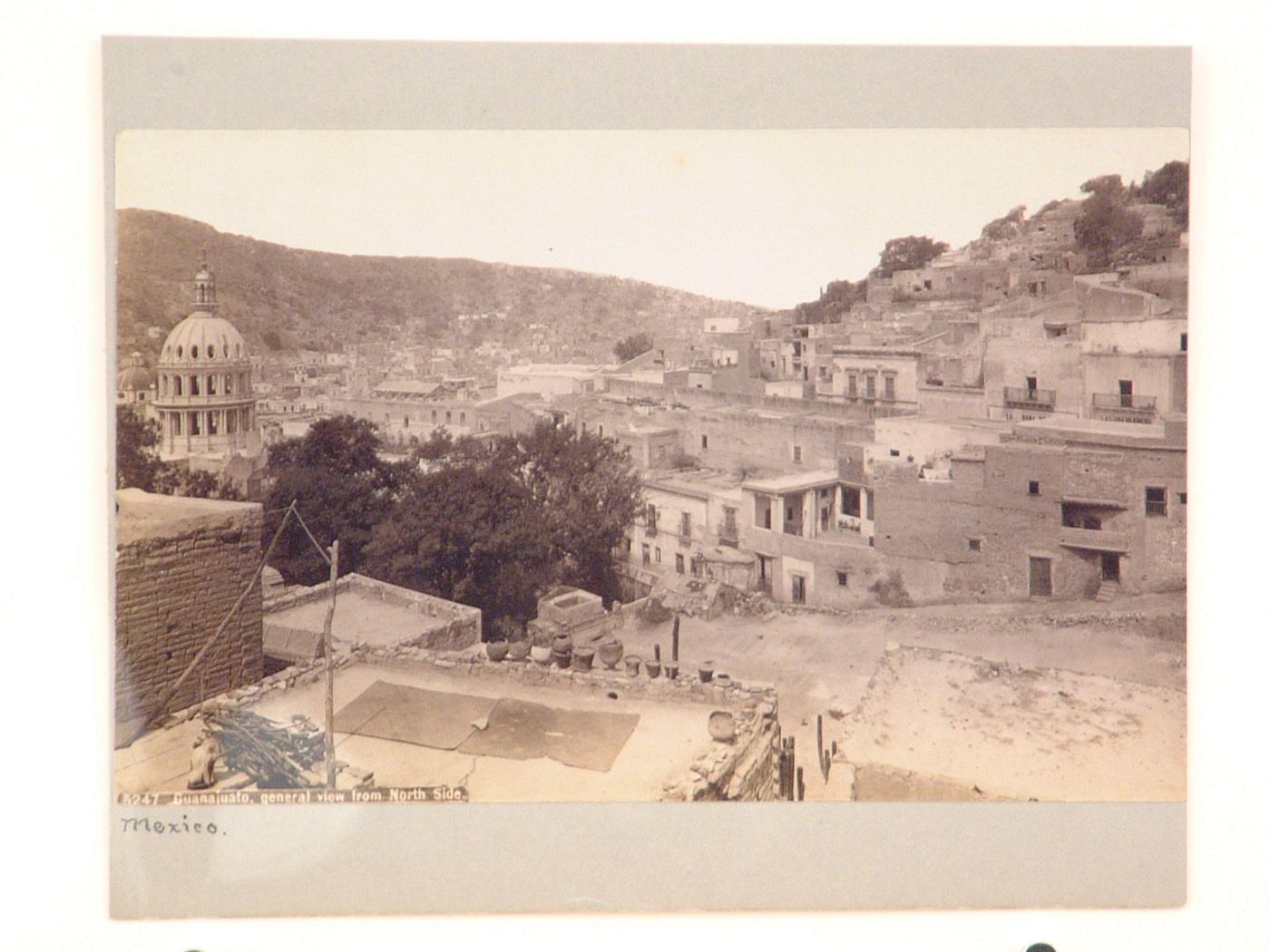 Partial view of Guanajuato taken from a roof top and showing houses, hills and the dome of a church, Mexico
