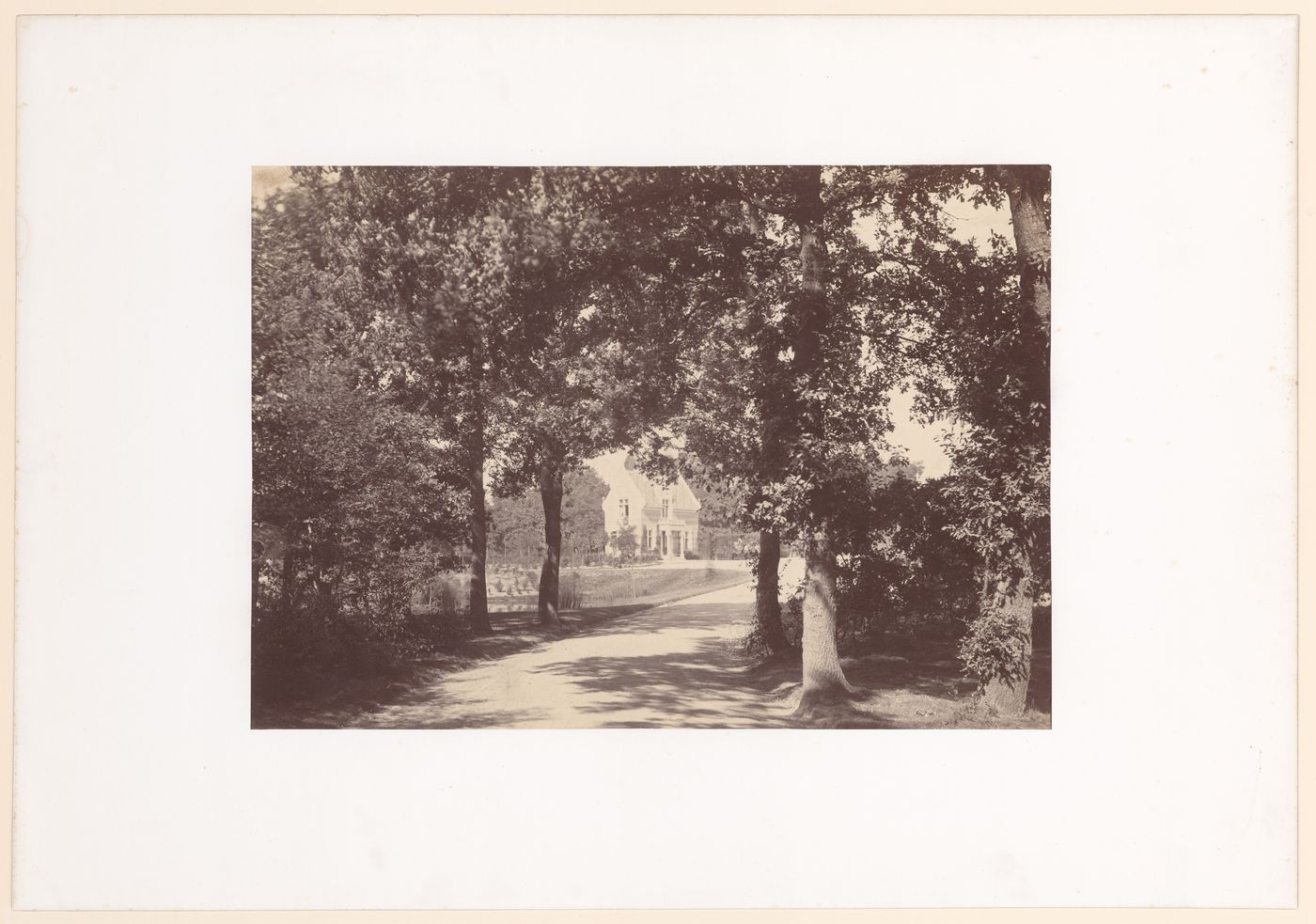 Distant view of unidentified gate house, one trees and road in foreground, Bois de Boulogne, Paris, France