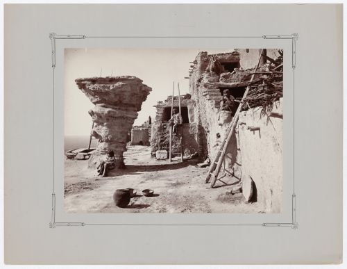 View of Dance Rock, Walpi, on the First Mesa, showing three Hopi people, ladders, and utensils, Hopi Reservation, Arizona, United States