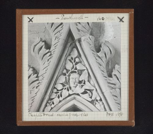 Detail view of canopy with foliate mask on tympanum in Chapter House, Southwell Minster, Southwell, Nottinghamshire, England
