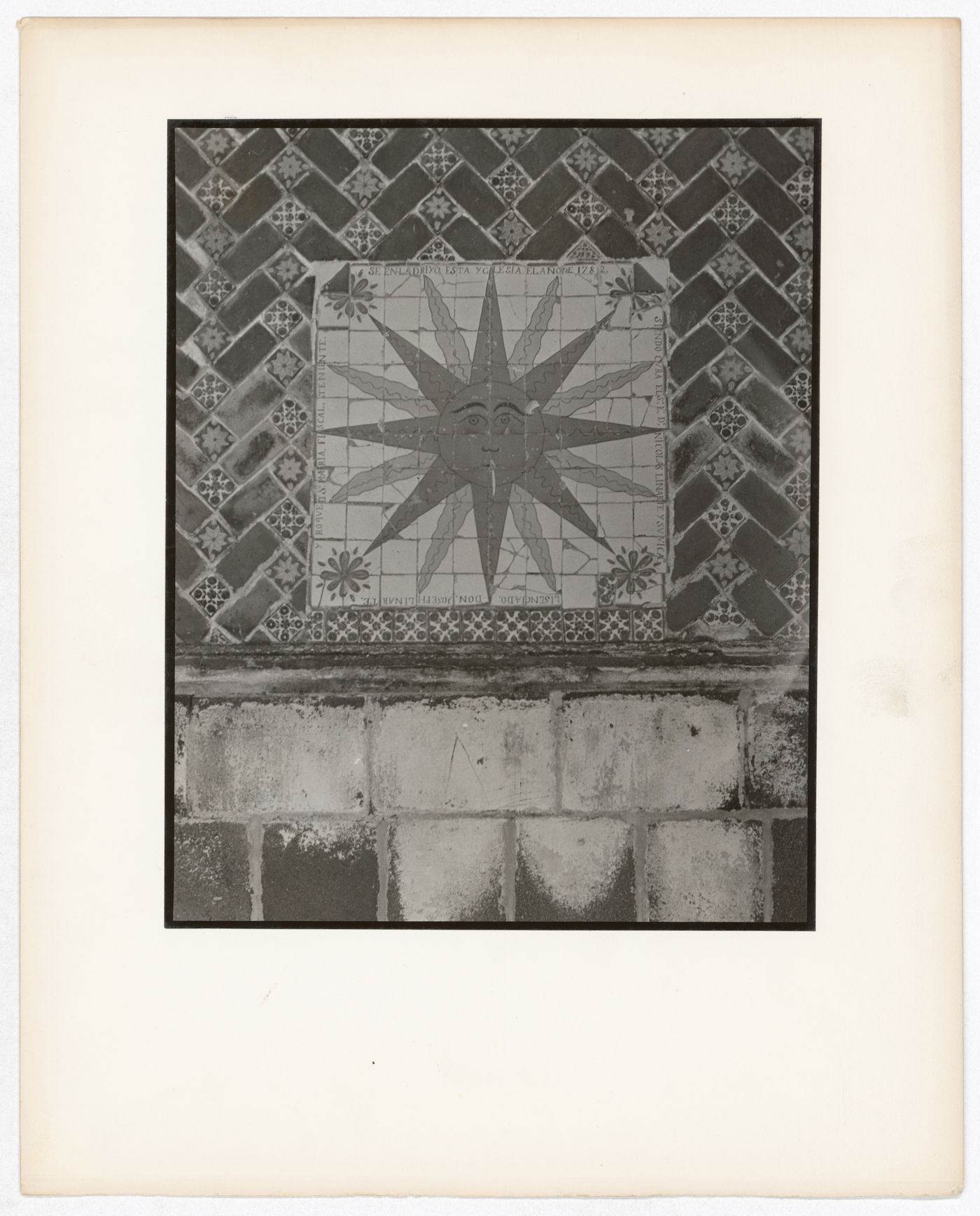 Close-up view of painted tiles, some of which form a sun design, Mexico