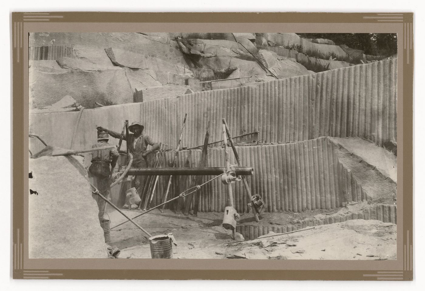 View of employees manning extraction equipment at the Stanstead Granite Quarries, Beebe, Quebec, Canada