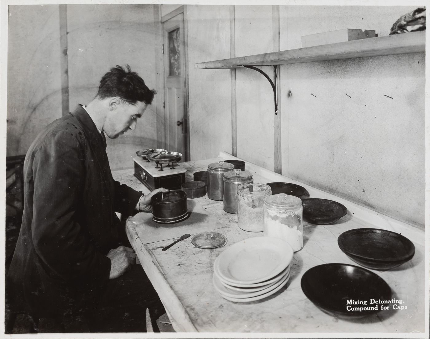 Interior view of worker mixing detonating compound for caps at the Energite Explosives Plant No. 3, the Shell Loading Plant, Renfrew, Ontario, Canada