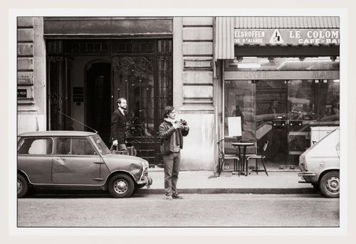 View of Gordon Matta-Clark holding a camera standing on Rue Beaubourg near Conical Intersect, Paris