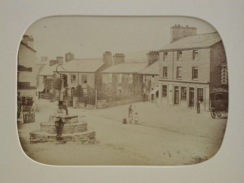 View of a village square with several houses and figures, and a coach at the right, England ?