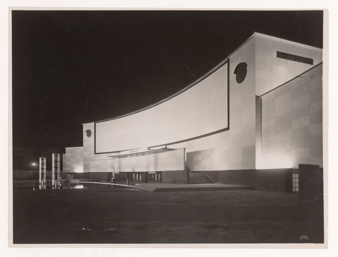 Exterior view at night of the Electricity and Light pavillion, Exposition internationale des arts et techniques dans la vie moderne, Paris, France