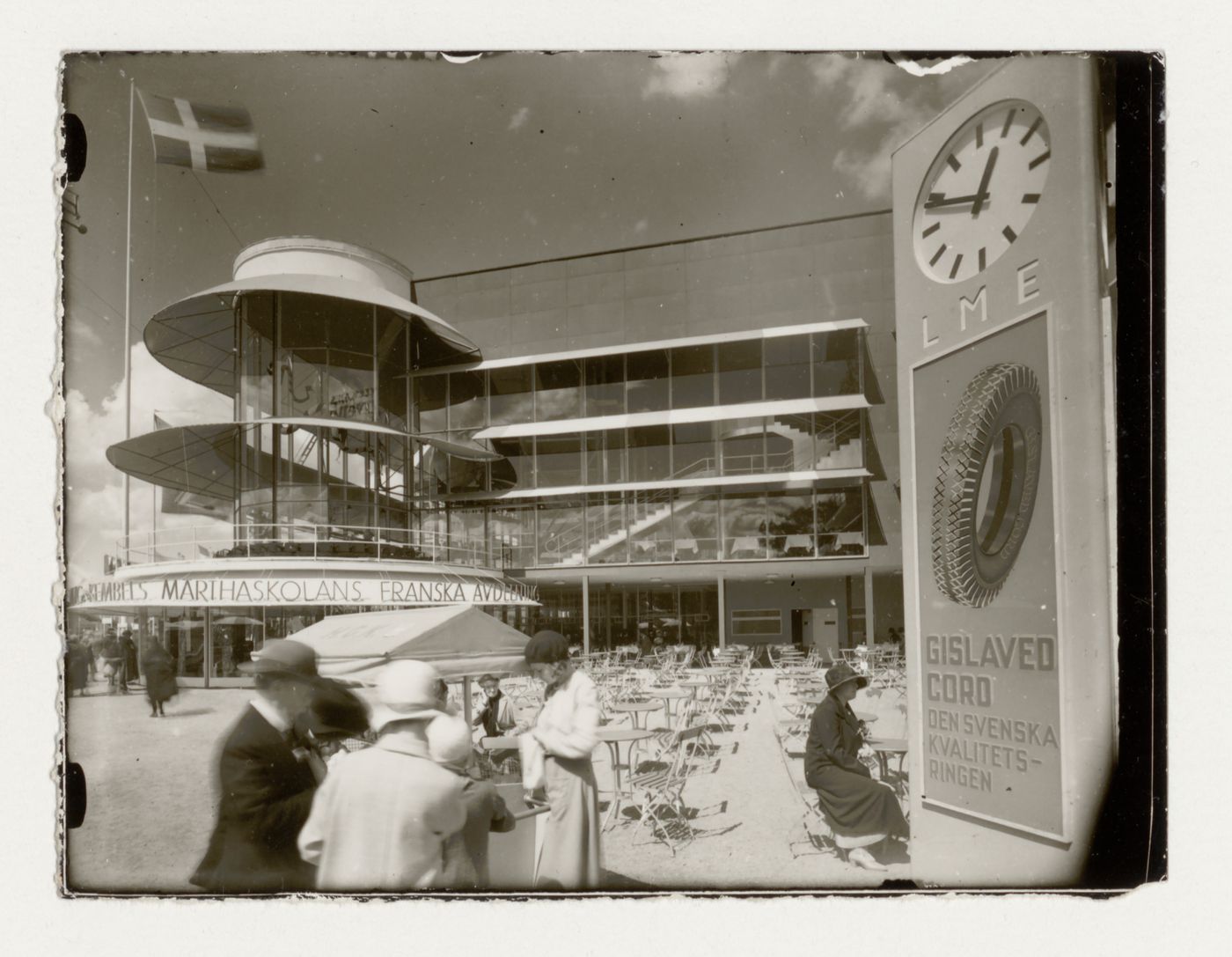View of the lateral façade of Paradise Restaurant at the Stockholm Exhibition of 1930 showing the terrace and an advertising post in the foreground, Stockholm