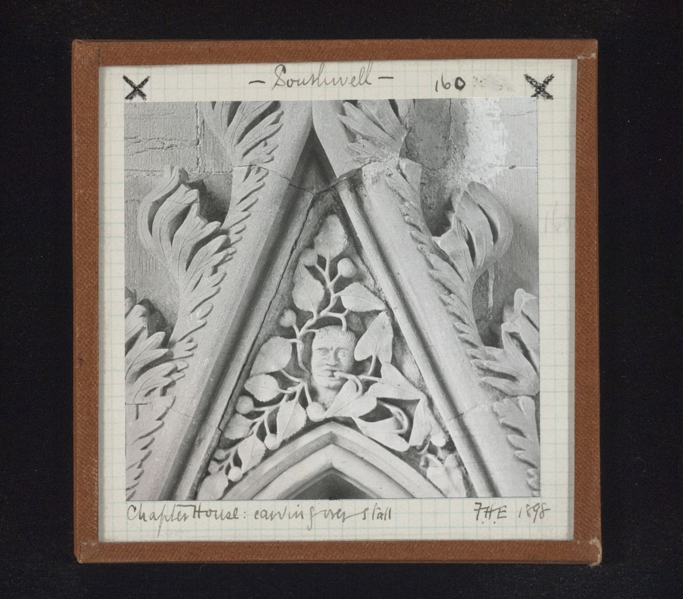 Detail view of canopy with foliate mask on tympanum in Chapter House, Southwell Minster, Southwell, Nottinghamshire, England