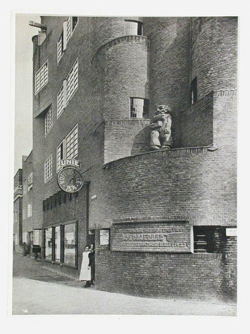 View of the plaque and sculpture at the base of the tower of the East or West Block of De Dageraad [The Dawn], Takstraat and Burgemeester Tellegenstraat, Amsterdam, Netherlands
