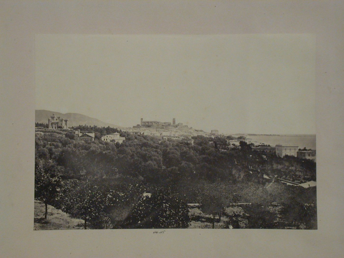 Distant view of a city on a bay showing a château, church [?] and other buildings, France [?]
