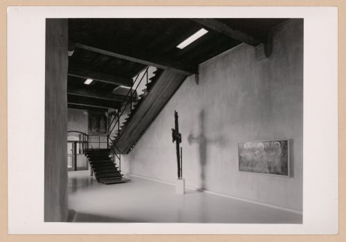 Interior view of a gallery showing  with a staircase, a freestanding painted crucifix and a painting, Museo di Castelvecchio, Verona, Italy