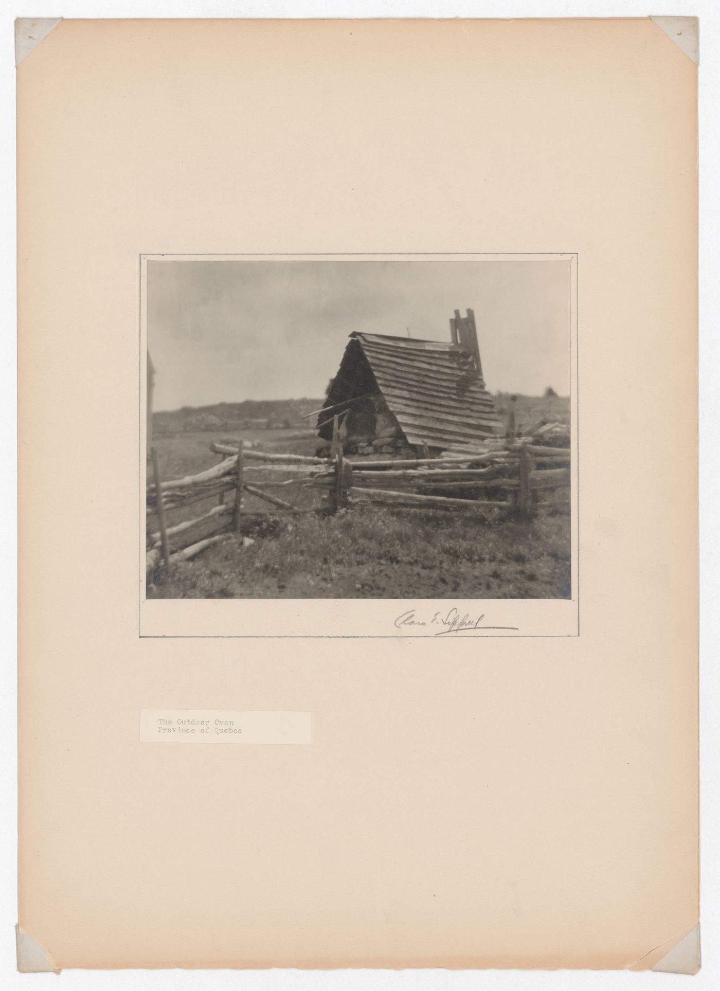 View of an outdoor oven with a rail fence in the foreground, Québec, Canada