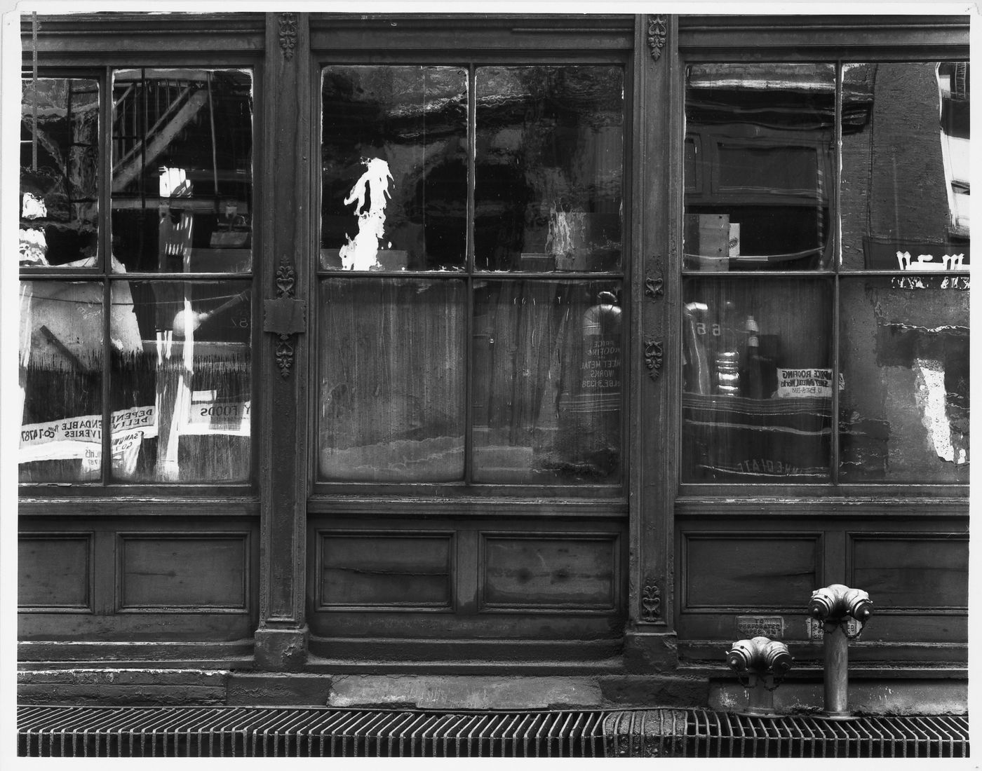 Partial view of the ground floor of a commercial building showing window reflections, Lower Manhattan, New York City, United States,