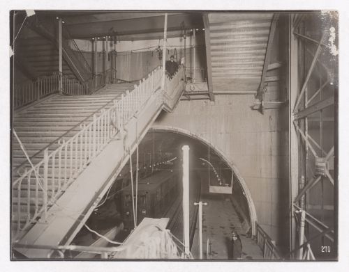 Construction of the Paris Metro, interior view of metro station with man on stairs and view of trains going towards Porte d'Orléans station, Paris, France