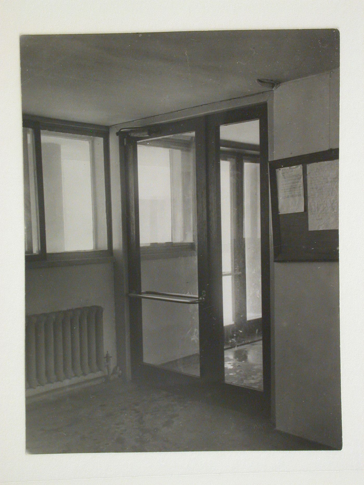 Interior view of an entrance to the People's Commissariat for Finance (Narkomfin) Apartment Building showing a bulletin board, 25 Novinskii Boulevard, Moscow