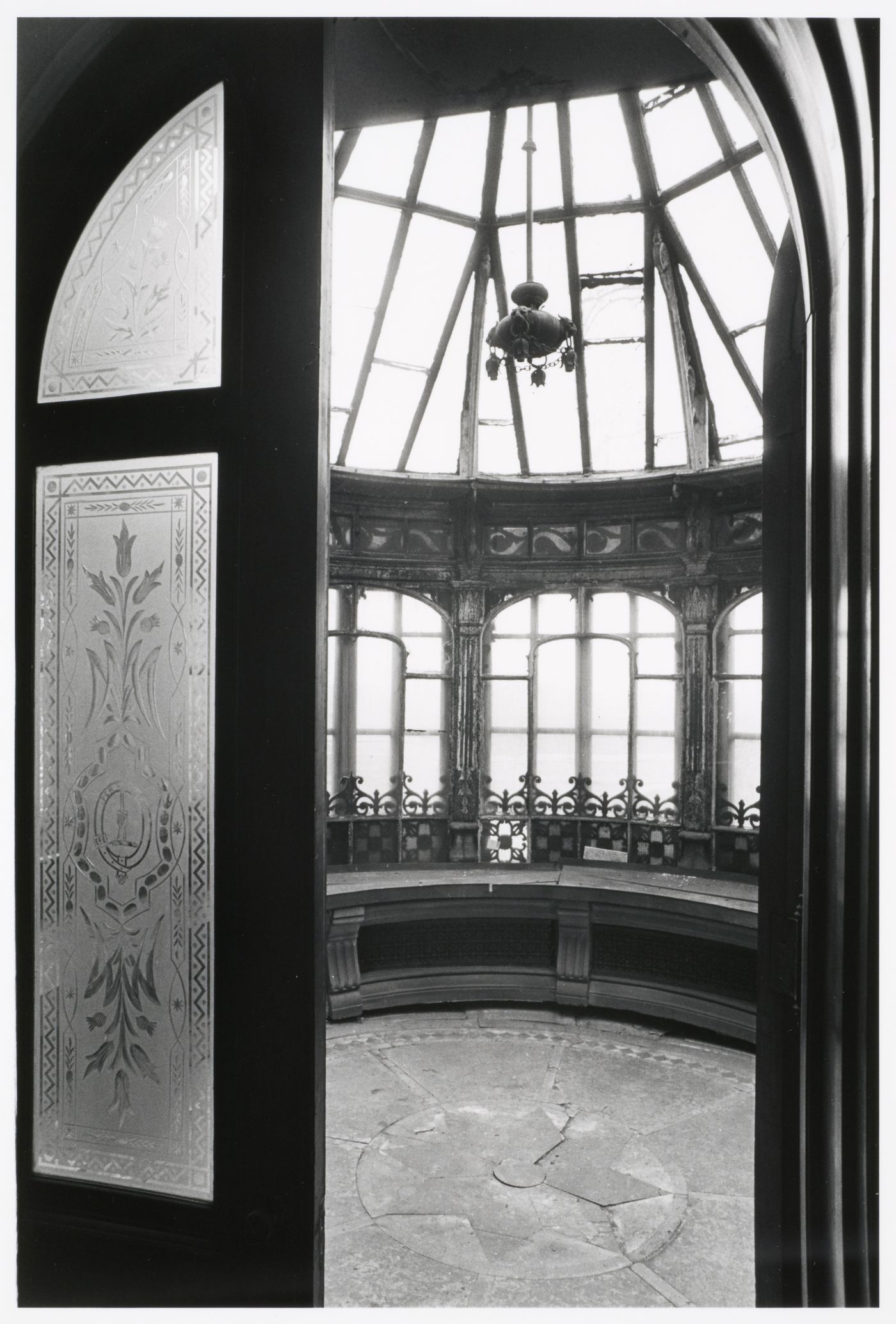 Interior view of the conservatory showing the frosted glass doors and the glazed and ironwork ceiling, Shaughnessy House, Montréal, Québec