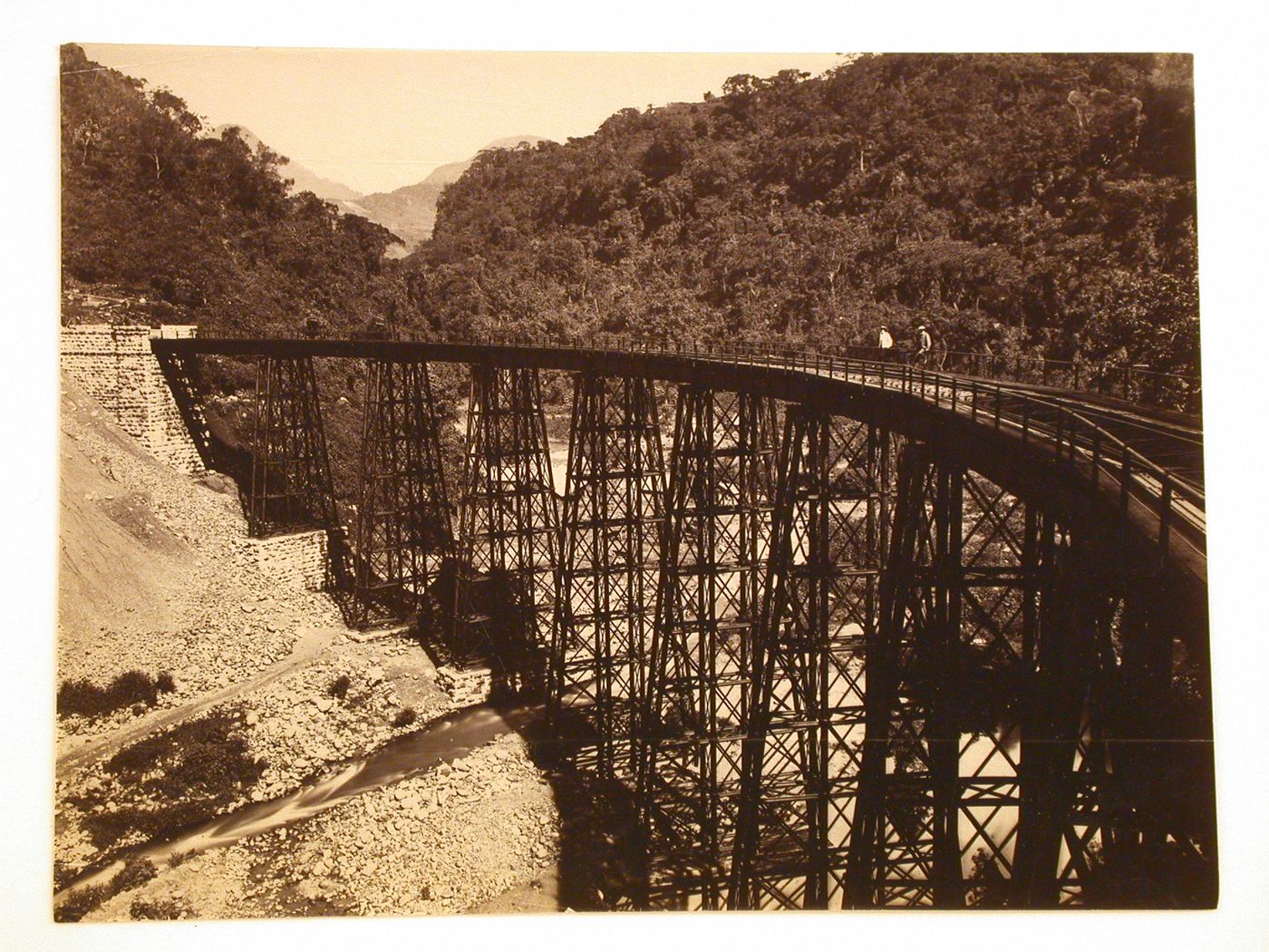 View of the railroad bridge over the Metlac Ravine with two men leaning on the railing, Veracruz-Llave, Mexico