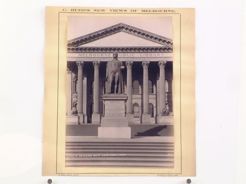 View of the statue of Sir Redmond Barry in front of the principal façade of Melbourne Public Library (now the State Library of Victoria), Australia