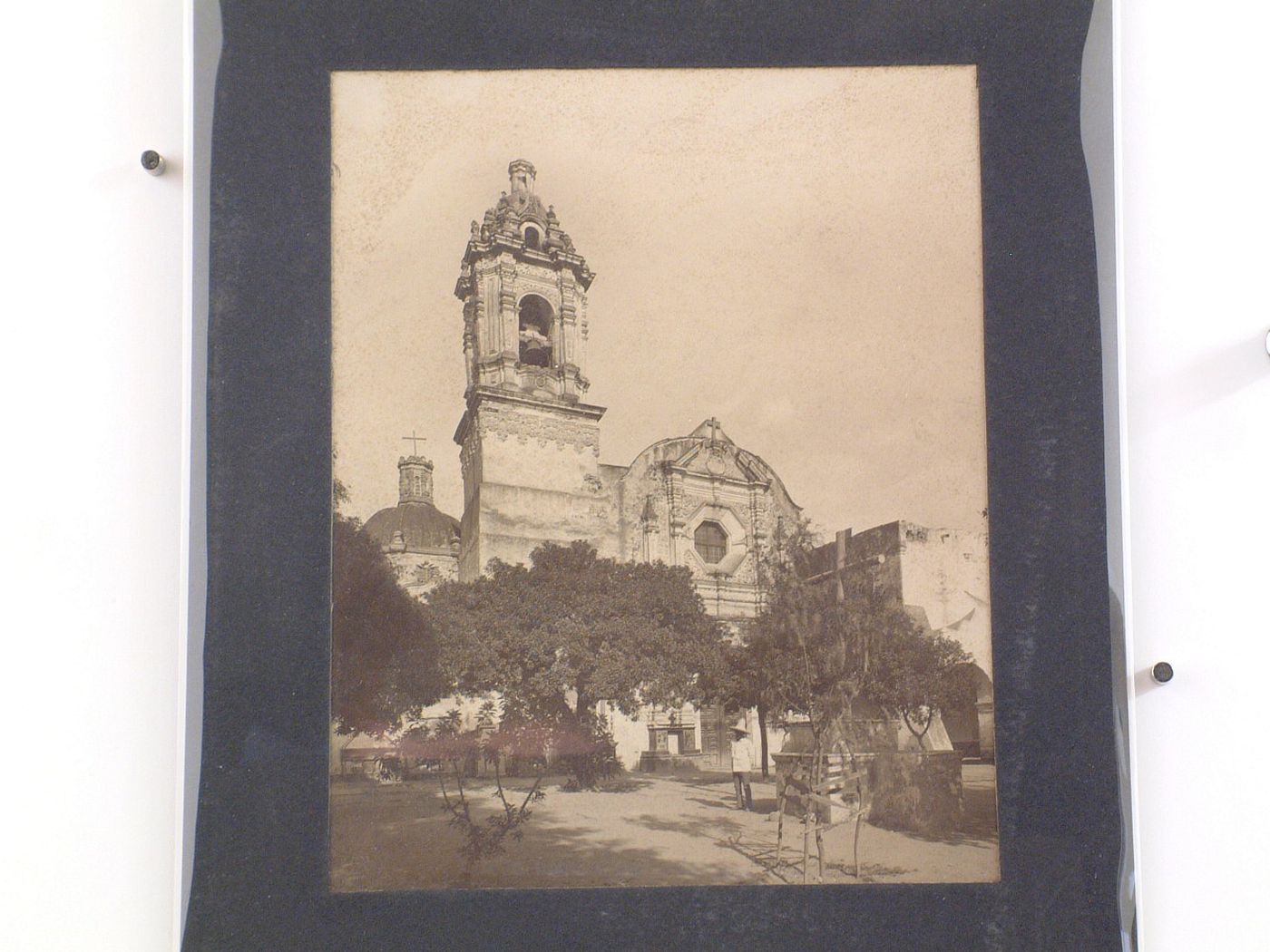 View of the Church of San Matías Apóstol showing trees and a man in the foreground, Iztacalco, Mexico