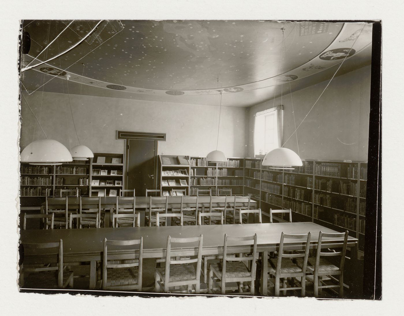 Interior view of the children's reading room of Stockholm Public Library showing tables, chairs and bookshelves, 51-55 Odengatan, Stockholm