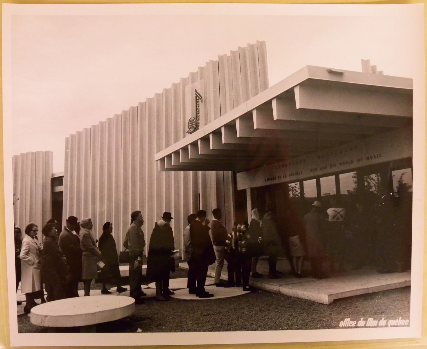 View of visitors standing in line at the Pavilion of the Jeunesses Musicales of Canada, Expo 67, Montréal, Québec