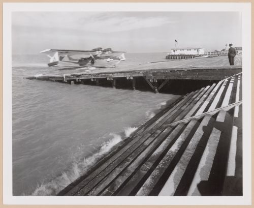 View of the Seaplane Ramp and Boathouse showing a plane landing, Consolidated Aircraft Corporation Assembly Plant, New Orleans, Louisiana