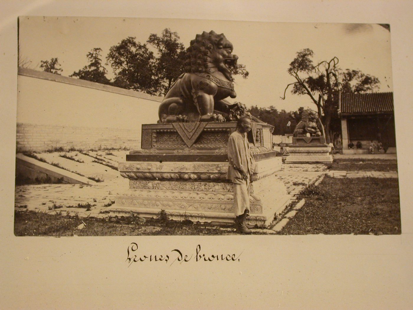 View of a pair of statues of a bronze a lioness and lion, Garden of the Clear Ripples [Qing Yi Yuan] (now known as the Summer Palace or Yihe Yuan), Peking (now Beijing), China