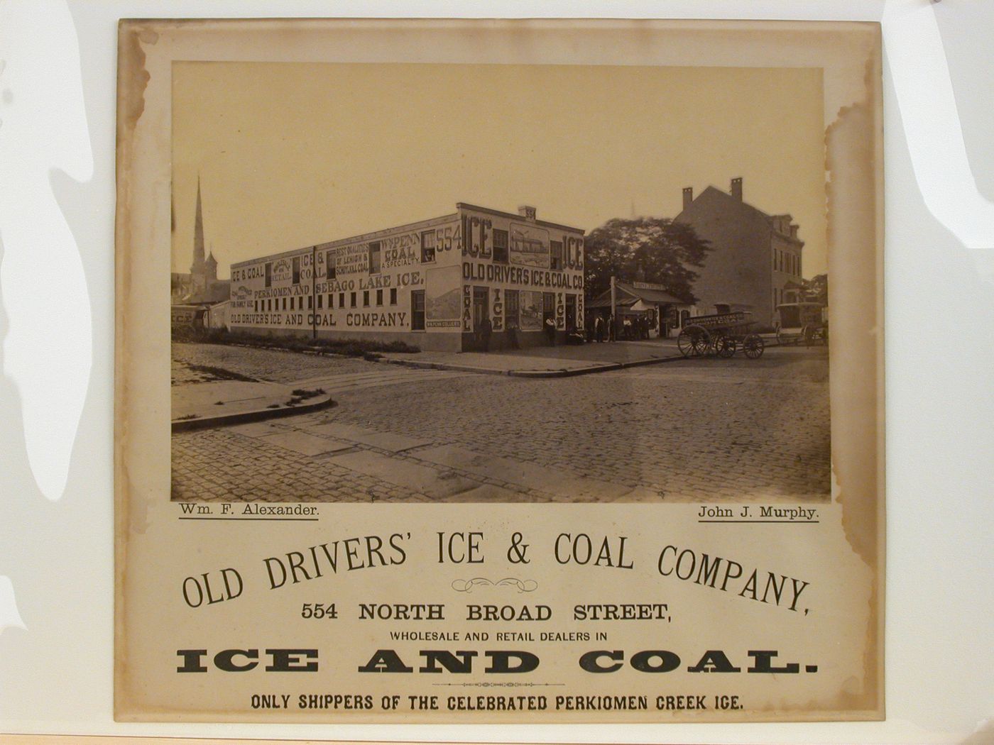 View of two-storey office building with narative murals and signage on front and side elevation, Philadelphia, Pennsylvania