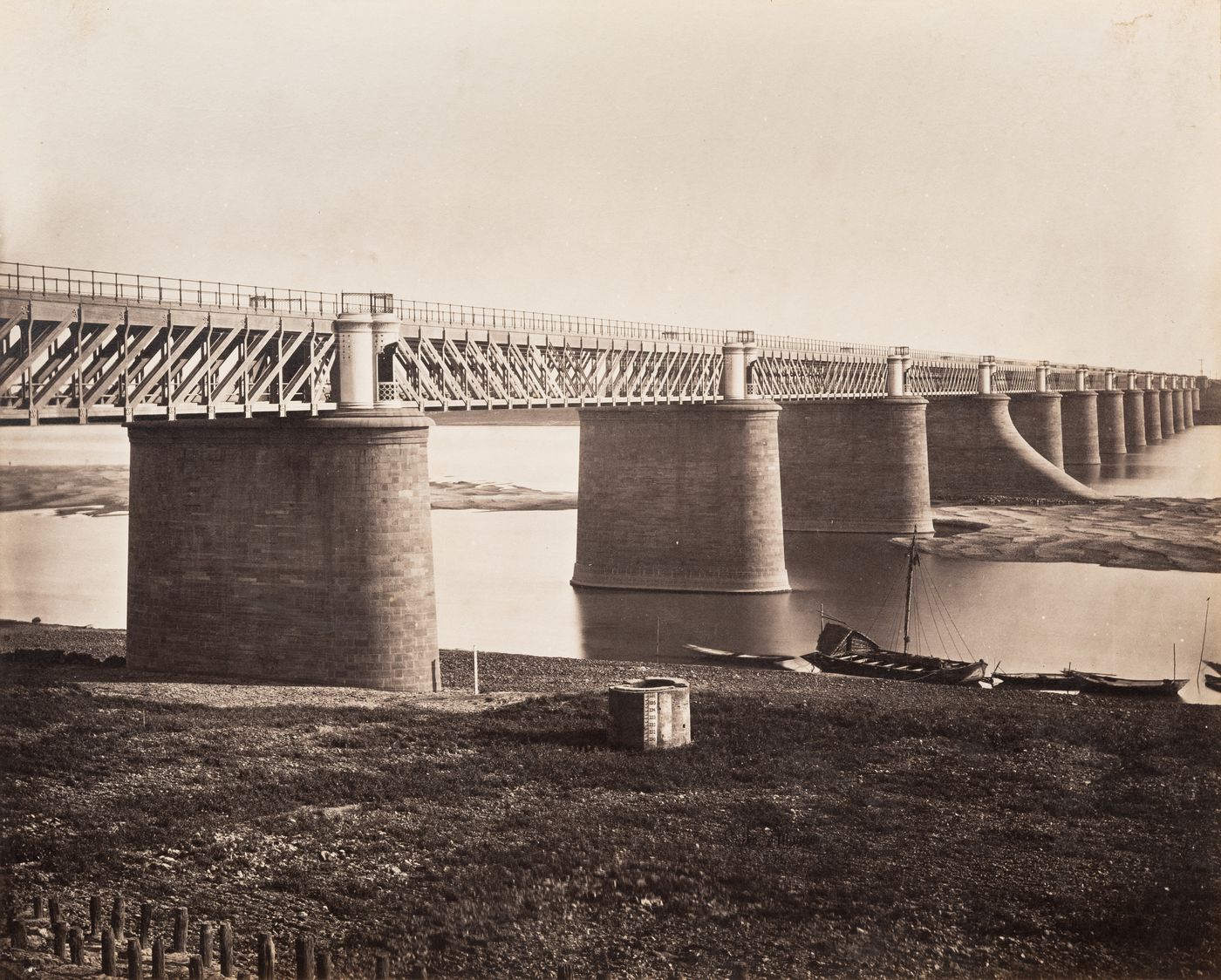 View of a railroad bridge, possibly known as the Papaman Bridge, across the Yamuna River (also known as the Jumna River), Allahabad, India