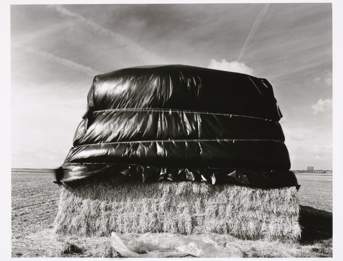View of stacked bales of straw covered in black plastic, Mainz, Germany