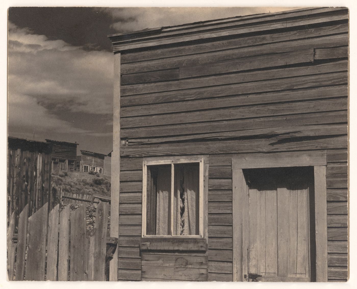 Southwestern town: Wooden houses and fences, close up, receding into distance