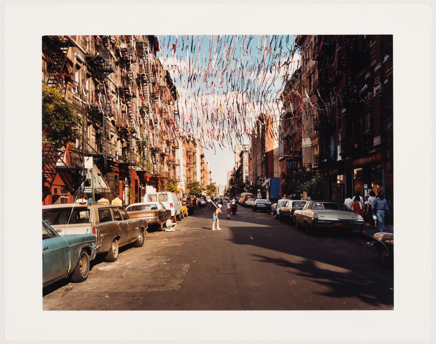 East 4th Street, children playing ball with rows of streamers hanging across street, New York City, New York