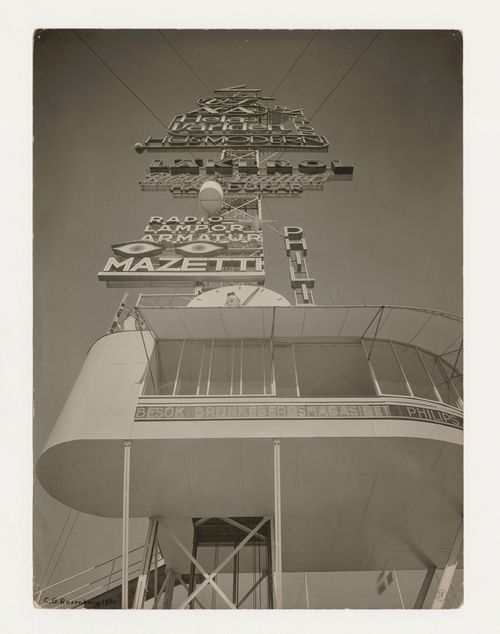Worm's-eye view of the base of the advertising mast at the Stockholm Exhibition of 1930 showing a clock and neon lettering designed by Sigurd Lewerentz, Stockholm