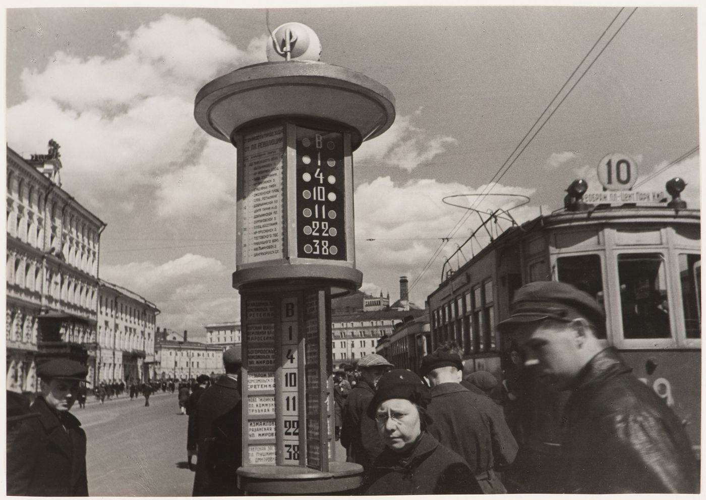 People waiting for street cars beside an information post in Revolution Square, Moscow