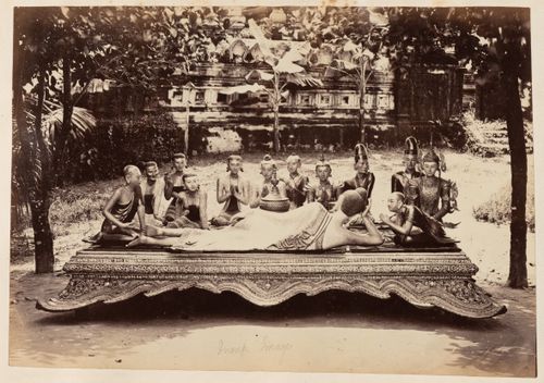 View of statues on a platform with a temple [?] in the background, Burma (now Myanmar)