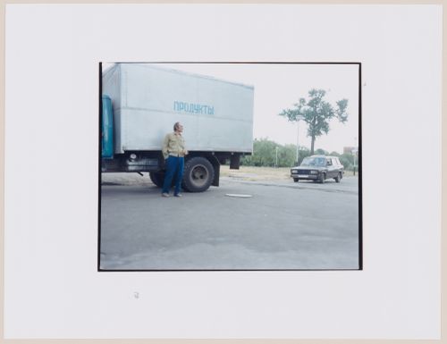 View of a truck, an automobile and a man on a road, Svetlyy, Kaliningradskaia oblast', Russia (from the series "In between cities")