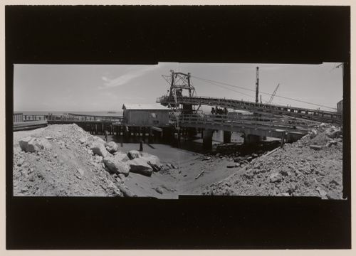 Panoramic composite photograph of the San Rafael Rock Quarry showing machinery and docks, Point San Pedro, San Rafael, Marin County, California, United States