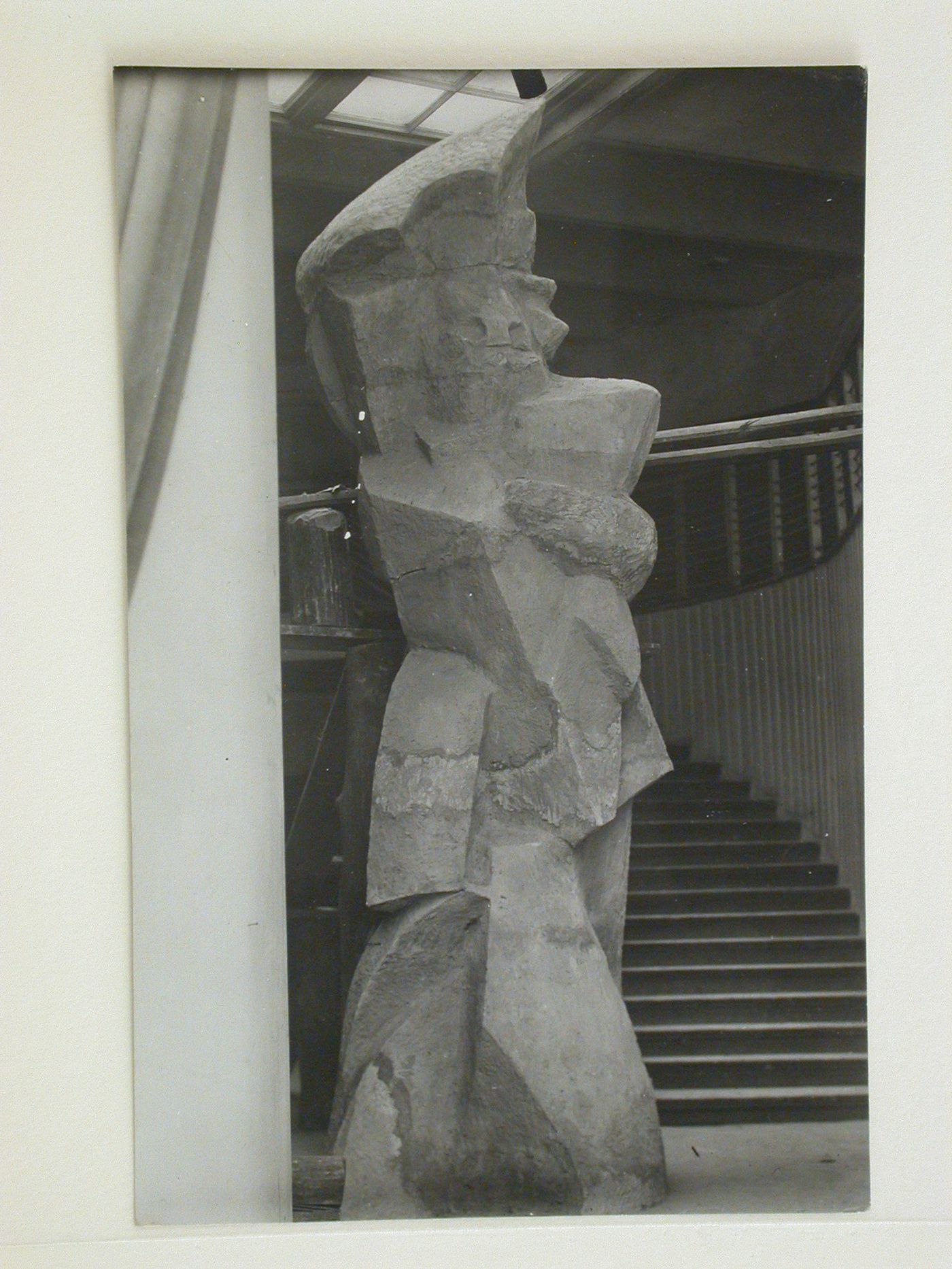 View of a monument to Mikhail Bakunin on a landing with stairs and a skylight in the background, Moscow