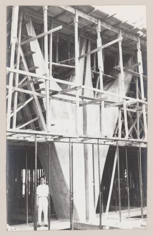View of Governor Juscelino Kubitschek's Complex, under construction, with man standing under scaffolding, Belo Horizonte, Brazil
