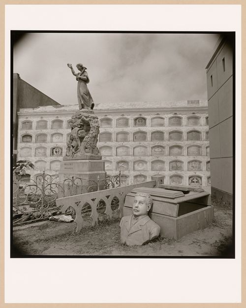 Cemetery with row mausoleums, broken bust in foreground, Lima, Peru