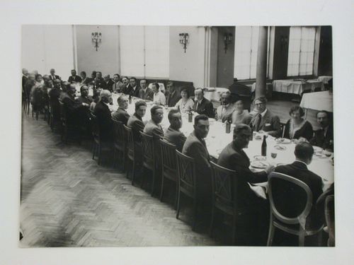 Group portrait of study tour members at dinner in Warsaw, Poland