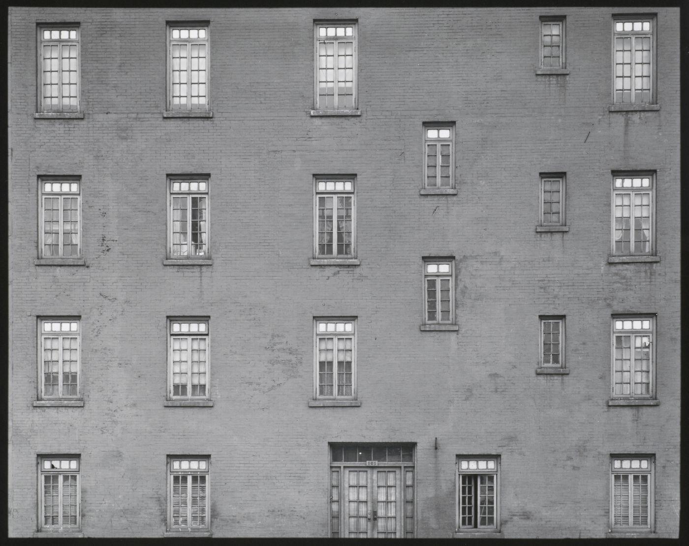 Building façade: abstract view of windows, door of building, New York