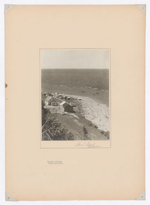 Partial view of a fishing village showing houses and sheds with the Saint Lawrence River [?] in the background, Gaspé Peninsula, Québec, Canada