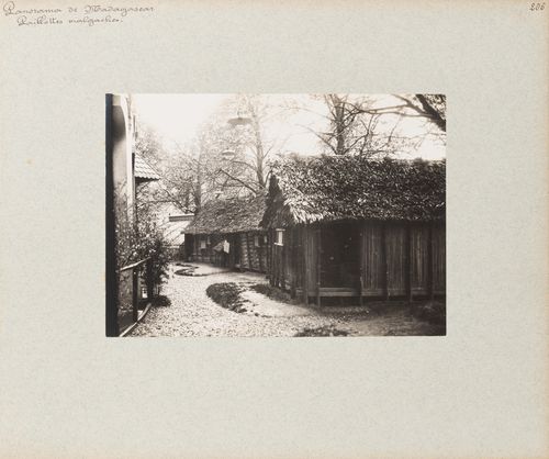 View of Malagasy houses with thatched roofs on grounds of Pavillon de Madagascar, Exposition universelle, 1900, Paris, France