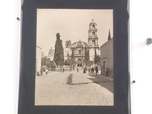 View of the principal façade of the Church of the Oratorio de San Felipe Neri showing the Chapel of Santa Casa de Loreto on the left and a street with people in the foreground, San Miguel de Allende, Mexico