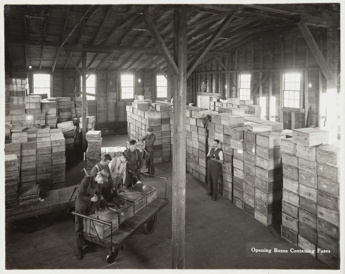 Interior view of workers opening boxes containing fuses at the Energite Explosives Plant No. 3, the Shell Loading Plant, Renfrew, Ontario, Canada