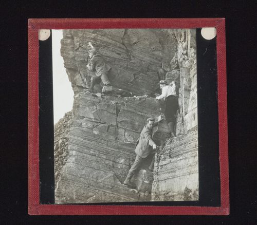 View of three unidentified men climbing