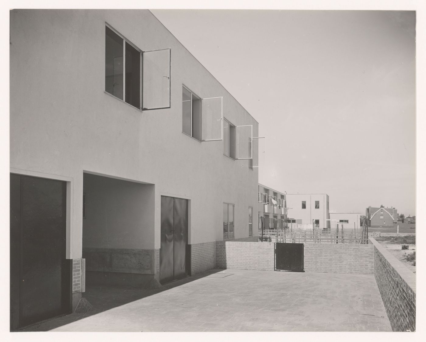 View of the rear façade of industrial row houses showing a covered walkway, Hoek van Holland, Netherlands