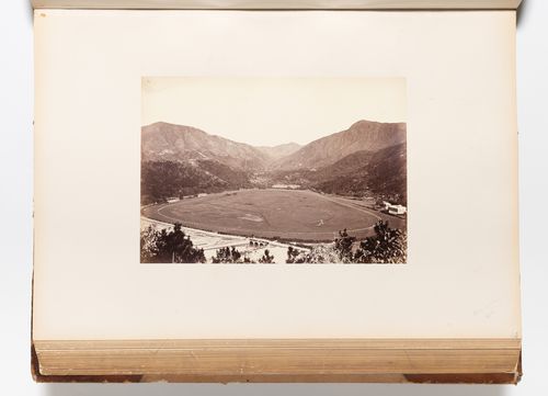 View of the Race Course at Happy Valley (also known as Wong Nei Chong Valley) showing the village of Wong Nei Chong in the background, Hong Kong (now Hong Kong, China)