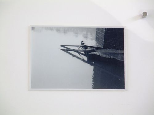 View of steel beams at base of brick bridge over water